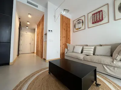 a living room with a couch and a coffee table at Atico Torre Tavira Ascensor Grupo AC Gestion in Cádiz