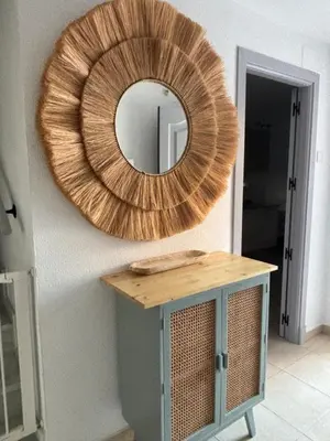 a mirror on a wall with a table with at Soto de Vistahermosa in El Puerto de Santa María