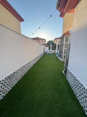 a balcony with green grass on the side of a building at Soto de Vistahermosa in El Puerto de Santa María
