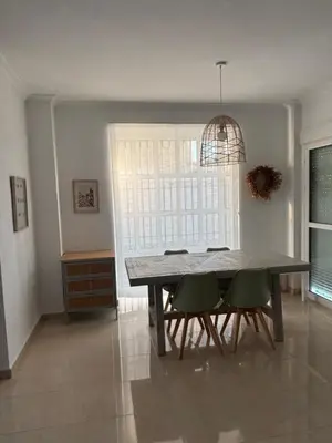 a dining room with a table and chairs and a window at Soto de Vistahermosa in El Puerto de Santa María
