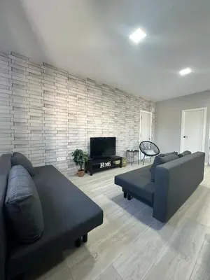 a living room with a couch and a television at Alojamiento Carlota in Chiclana de la Frontera