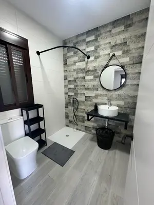 a bathroom with a toilet and a sink and a mirror at Alojamiento Carlota in Chiclana de la Frontera