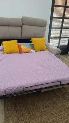 a bed with yellow pillows and purple sheets at Solera in Jerez de la Frontera