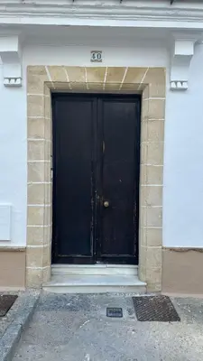 a black door of a building with the number at Solera in Jerez de la Frontera