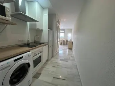 a kitchen with a washer and dryer in a room at Apartoyou - Vistahermosa Lux in El Puerto de Santa María
