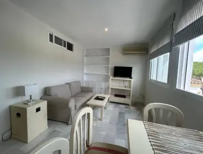 a living room with a couch and a table at Apartoyou - Vistahermosa Lux in El Puerto de Santa María