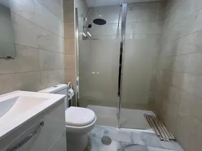 a bathroom with a shower and a toilet and a sink at Apartoyou - Vistahermosa Lux in El Puerto de Santa María