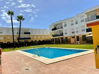a swimming pool in front of a building at La Bodega del Mar - Luminoso y céntrico apto con piscina en verano y parking in El Puerto de Santa María