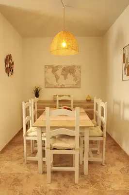 a dining room with a white table and chairs at La Bodega del Mar - Luminoso y céntrico apto con piscina en verano y parking in El Puerto de Santa María