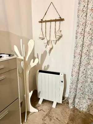 a room with a white radiator and a tree at La Bodega del Mar - Luminoso y céntrico apto con piscina en verano y parking in El Puerto de Santa María