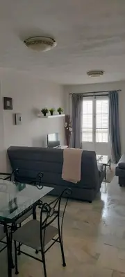 a living room with a couch and a table at Apartamento Danubio in El Puerto de Santa María