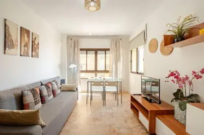 a living room with a couch and a table at Apartamento playa Victoria in Cádiz
