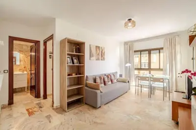 a living room with a couch and a table at Apartamento playa Victoria in Cádiz