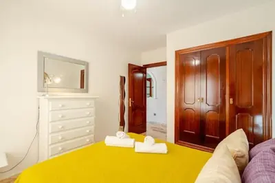 a living room with two towels on a yellow rug at Apartamento playa Victoria in Cádiz