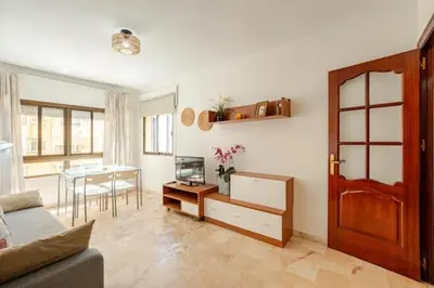 a living room with a table and a dining room at Apartamento playa Victoria in Cádiz