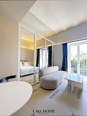 a living room with a couch and a table at CASA MONTI Sherry Suites in Jerez de la Frontera
