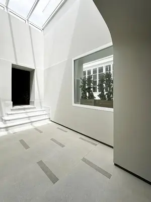 an empty white room with a window in a building at CASA MONTI Sherry Suites in Jerez de la Frontera