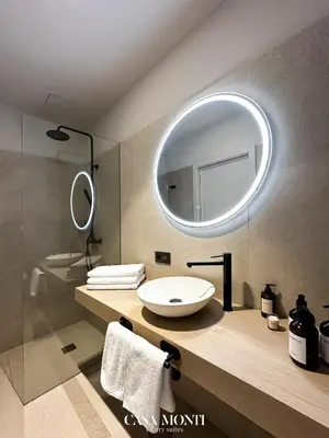 a bathroom with a sink and a mirror at CASA MONTI Sherry Suites in Jerez de la Frontera