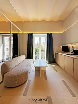 a living room with a couch and a table at CASA MONTI Sherry Suites in Jerez de la Frontera