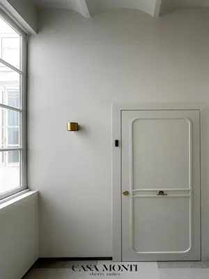 a white room with a white door and a window at CASA MONTI Sherry Suites in Jerez de la Frontera