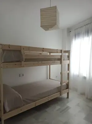 a bunk bed in a room with a window at Apto en El Puerto de Santa María in El Puerto de Santa María