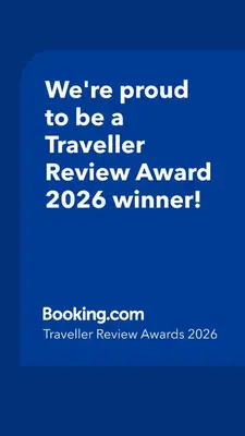 a blue sign that says were proud to be a traveller reviewagency winner at ESCAPADAS ROMÁNTICAS Gavira Apartamento in Rota