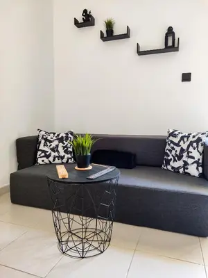 a living room with a couch and a table at ESCAPADAS ROMÁNTICAS Gavira Apartamento in Rota