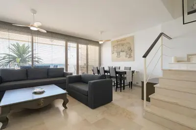 a living room with a couch and a table at Apartoyou - Breva Playa in El Puerto de Santa María