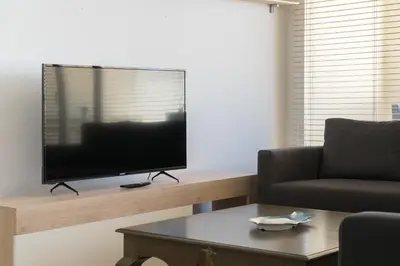 a living room with a flat screen tv on a table at Apartoyou - Breva Playa in El Puerto de Santa María