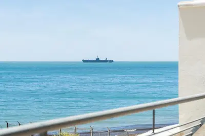 a large ship in the ocean near the beach at Apartoyou - Breva Playa in El Puerto de Santa María