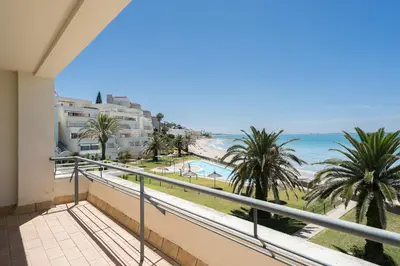a balcony with a view of the beach and buildings at Apartoyou - Breva Playa in El Puerto de Santa María