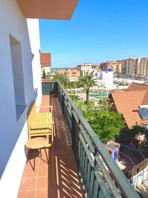 a balcony with two benches and a view of a city at ÁTICO Centro y Playa in Sanlúcar de Barrameda