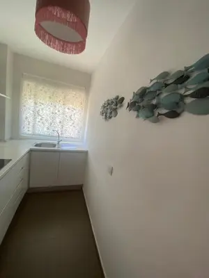 a white kitchen with a sink and a window at Sanlúcar mar in Sanlúcar de Barrameda