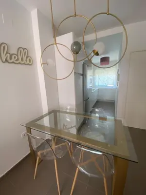 a glass table and a chair in a room at Sanlúcar mar in Sanlúcar de Barrameda