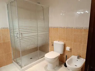 a bathroom with a toilet and a glass shower at Plaza Plateros in Jerez de la Frontera