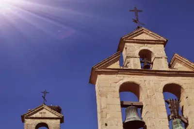 a church steeple with two crosses and a bell at Plaza Plateros in Jerez de la Frontera