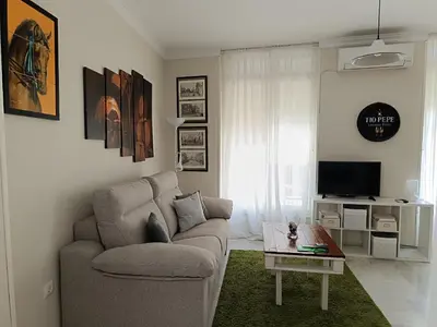a living room with a couch and a table at Plaza Plateros in Jerez de la Frontera