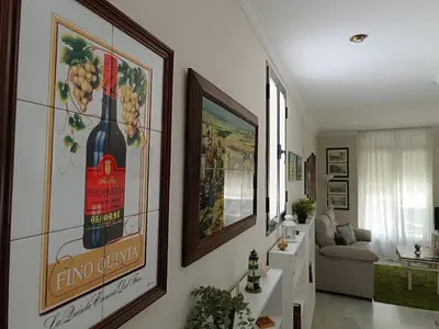 a living room with a painting of a bottle of wine at Plaza Plateros in Jerez de la Frontera