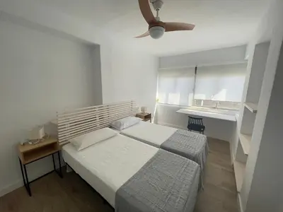 a bedroom with a bed and a ceiling fan at La Isla Centro in San Fernando