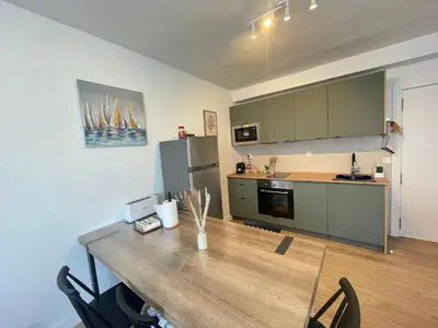 a kitchen with a wooden table and a counter top at La Isla Centro in San Fernando