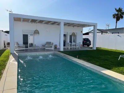 a swimming pool in the backyard of a house at La Fontaniega in Cádiz
