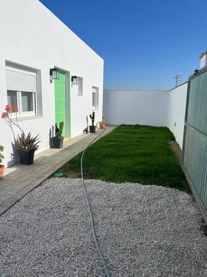 a garden with a hose attached to a building at La Fontaniega in Cádiz