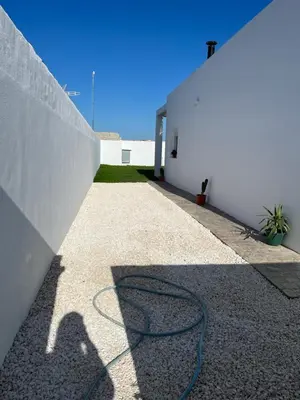 a shadow of a hose on the side of a building at La Fontaniega in Cádiz
