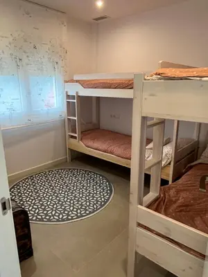 a room with two bunk beds and a window at La Fontaniega in Cádiz