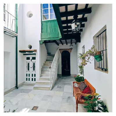 a hallway of a house with stairs and a door at LA BARAKA APARTAMENTO in Jerez de la Frontera