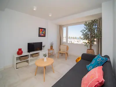 a living room with a couch and a tv at Sibs Sanlúcar Atlantico Playa Vistas Reformado in Sanlúcar de Barrameda