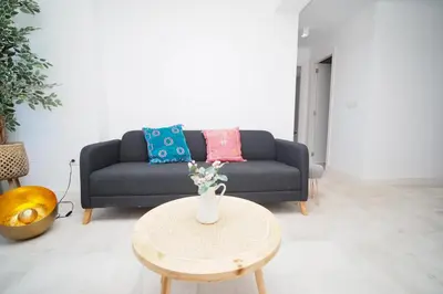 a living room with a couch and a table at Sibs Sanlúcar Atlantico Playa Vistas Reformado in Sanlúcar de Barrameda