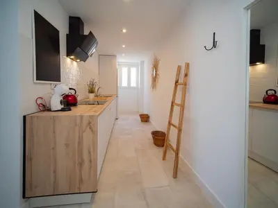 a kitchen with a counter and a ladder in it at Sibs Sanlúcar Atlantico Playa Vistas Reformado in Sanlúcar de Barrameda