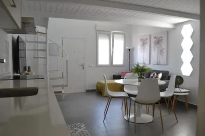 a living room with a table and chairs at Apartamento en Playa Victoria in Cádiz