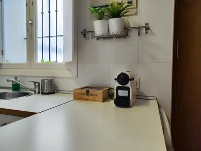 a kitchen counter top with a coffee maker on it at Suite del Mercado Little Apartments in Cádiz